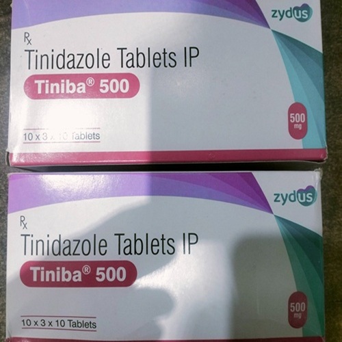 Tiniba 500mg tablets multiple boxes stacked, Tinidazole antibiotic for infection treatment