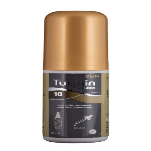 Close-up of Tugain 10% Minoxidil bottle with gold cap